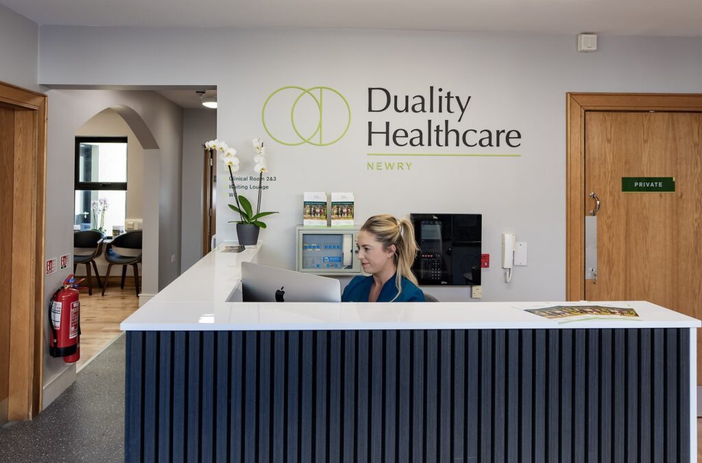 A woman sitting at a reception desk.